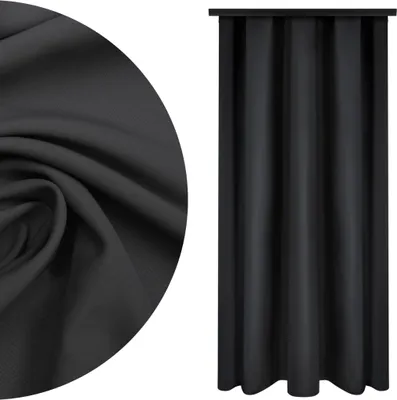 A close-up of black fabric and a black curtain.