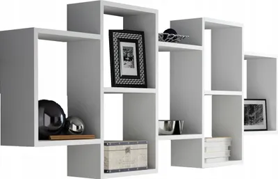 A white modular wall shelf unit with decorative items.