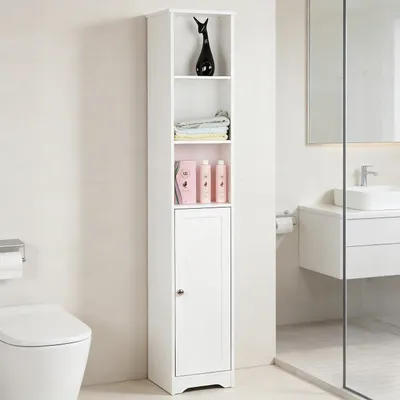 A tall, narrow white cabinet with shelves and a door, placed in a bathroom next to a toilet and a sink.