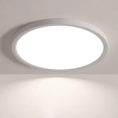 A white, round LED ceiling light mounted on a white ceiling.