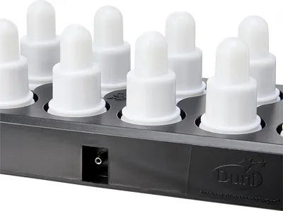 A close-up, angled view of a black charging base with multiple white LED tea lights inserted.