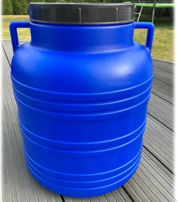 A blue plastic barrel with handles and a black lid sits on a wooden deck outdoors.
