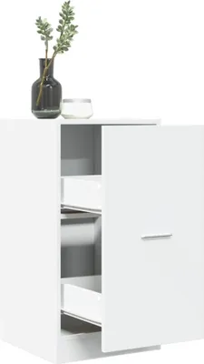 A white cabinet with two drawers and a closed door, on top of which sits a vase with greenery and a candle.