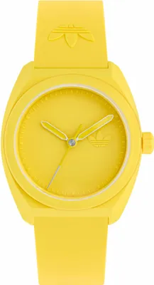 A studio shot of a yellow Adidas watch against a white background.