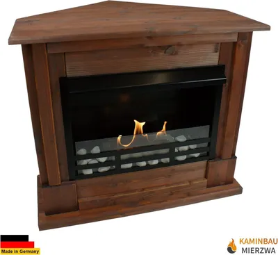 A corner fireplace with a wooden frame and a glass front showing flames and decorative stones.