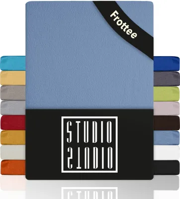 A stack of folded fabric items, likely bed sheets, with the main item in a light blue color. A black band with white text is visible on the top right corner, and a black rectangular logo with white text is at the bottom.