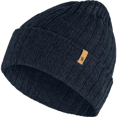 A dark blue knitted beanie with a small tan leather patch on the front.