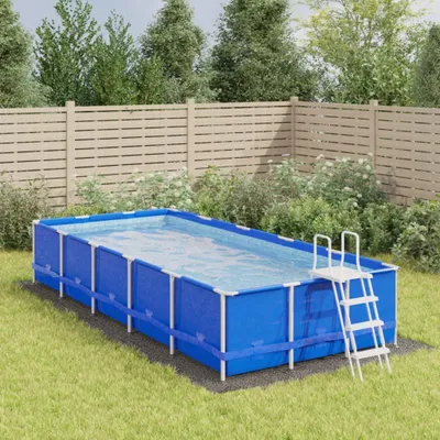 An above-ground rectangular swimming pool set up on a grassy lawn, with a wooden fence in the background.