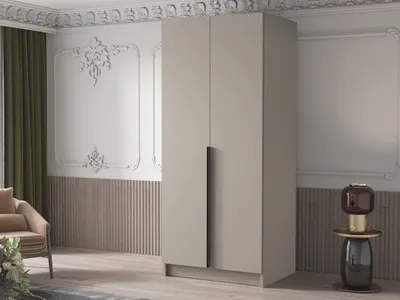 A modern wardrobe in a room with decorative wall molding and a chair.