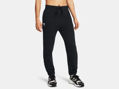 A person is wearing black sweatpants and sneakers against a white background.