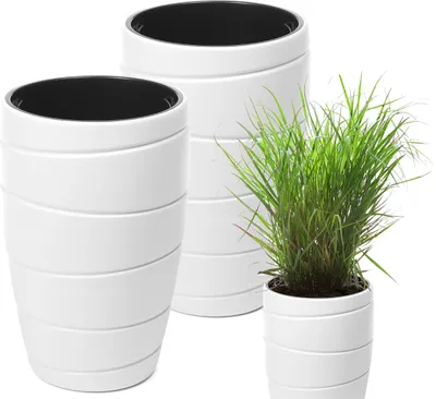 Three white planters of varying sizes are arranged on a white background. The largest planter is on the left, a medium-sized planter is behind it, and the smallest planter with a green plant is on the right.