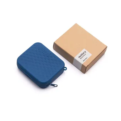 A blue silicone cutlery holder and a brown cardboard box are placed on a white background.