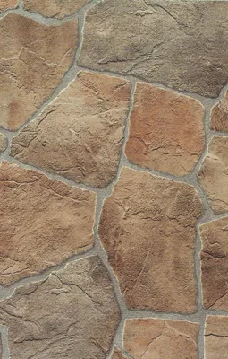A close-up view of a stone-like floor covering with irregular shapes and grout lines.
