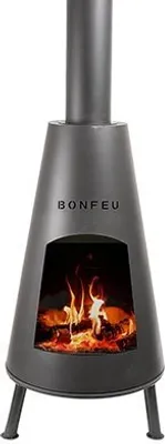 A dark gray outdoor fireplace with a chimney and a fire burning inside.