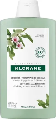 A bottle of Klorane shampoo with almond milk.