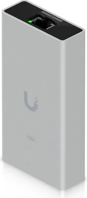 A silver and black Ubiquiti Ethernet Adapter with a green indicator light.