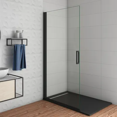 A modern bathroom with a black framed glass shower enclosure and a wooden floor.
