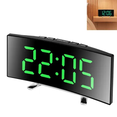 A digital alarm clock with a curved mirror display showing the time.