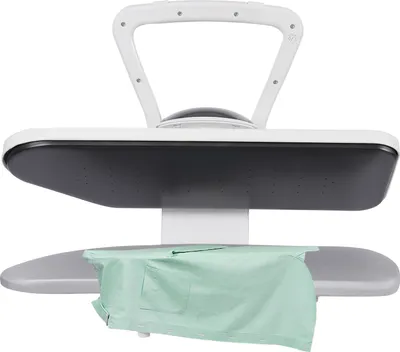 A steam ironing press with a green shirt placed on the ironing board.
