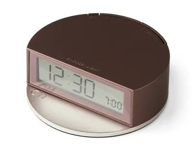 A digital alarm clock shown from a diagonal angle on a white background.