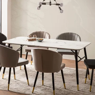 A dining table with chairs in a modern setting.