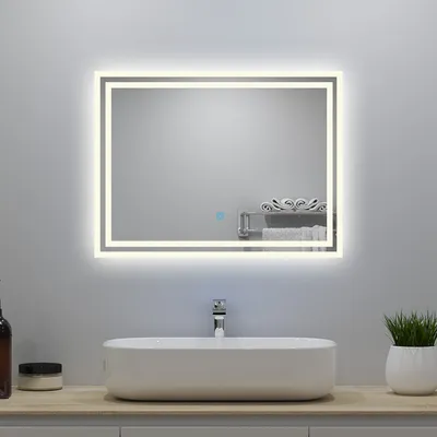 A modern bathroom vanity with a rectangular vessel sink and a lit mirror above it.