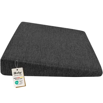 A dark gray ergonomic seat cushion is shown from a side angle on a white background.