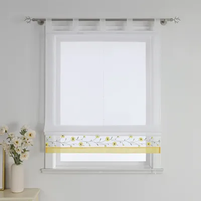 A white sheer Roman blind with a yellow floral border is displayed on a window.