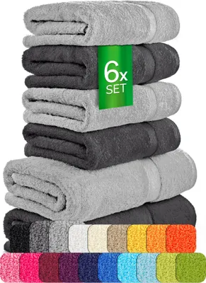 A stack of folded towels in different shades of gray, with a row of colorful towels at the bottom.