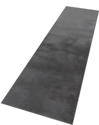 A long, rectangular rug with a textured, dark gray surface, presented on a white background.