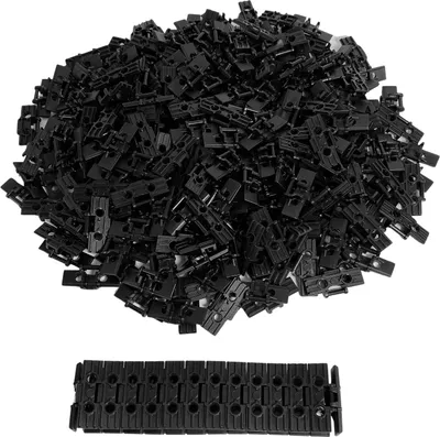 A pile of black LEGO Technic chain links, with one chain link laid out below.
