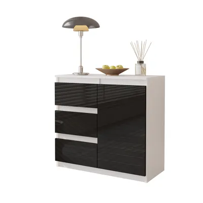A white and black sideboard with a lamp, a bowl of fruit, and a diffuser on top.