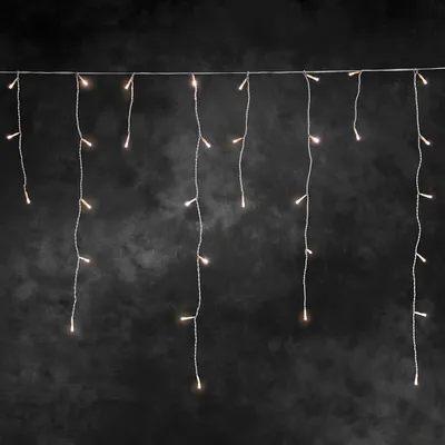 A string of LED lights hangs against a dark, textured background.