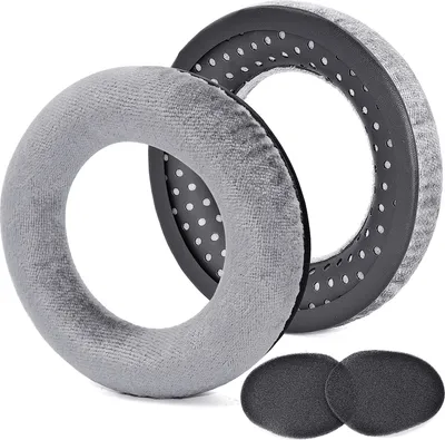 Two grey headphone ear pads and two smaller grey foam pads are arranged on a white background.
