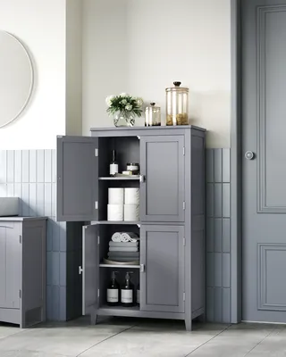 A gray bathroom cabinet with its doors open, displaying various items inside, set against a tiled wall.