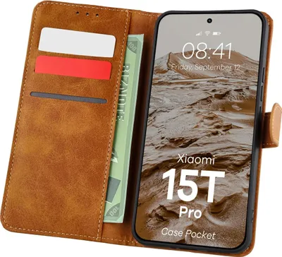 A brown leather wallet-style phone case is open, showing a phone screen with the time and date displayed, along with some cards and a bill inside the wallet slots.