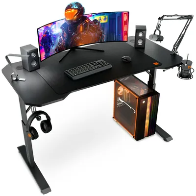 A gaming desk setup with a computer, monitor, keyboard, mouse, speakers, microphone, and headphones.