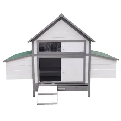 A white and gray wooden chicken coop with a green roof, shown from the front.