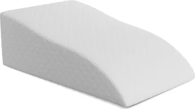 A white wedge pillow on a white background.