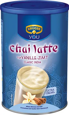 A can of Krüger Chai Latte with a depiction of a glass of chai latte, vanilla, and cinnamon sticks.