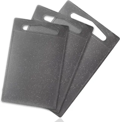 A set of three gray cutting boards stacked on a white background.