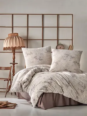 A bedroom scene with a bed, lamp, and chair.