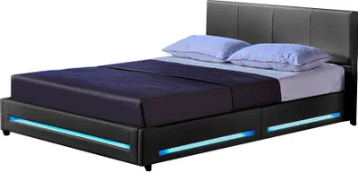 A black upholstered bed frame with blue LED lighting and two pillows on a white background.