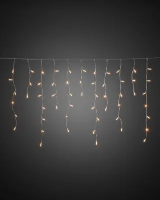 A string of LED icicle lights hanging against a dark gray background.