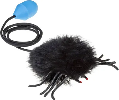A black, fuzzy toy spider with a blue bulb and black cord on a white background.