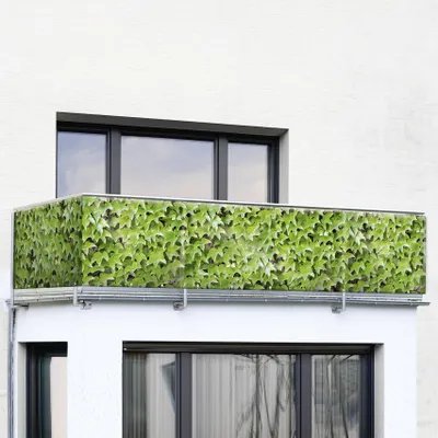 A balcony railing covered with a green ivy pattern.