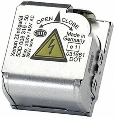 A close-up studio shot of a silver electronic ballast for a car headlight.