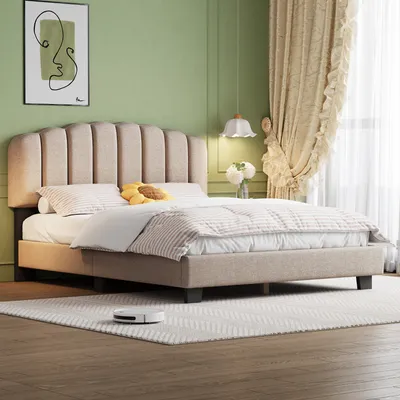 A bedroom scene featuring a bed with bedding, a headboard, and decorative elements like a painting and curtains.
