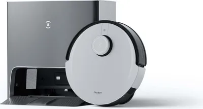 A robot vacuum cleaner and its charging station are shown against a white background.