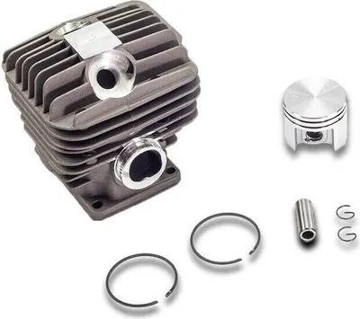 A set of engine parts, including a cylinder and piston, laid out on a white background.